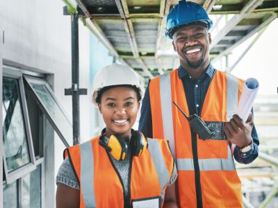 happy-proud-african-american-engineers-construction-site-planning-building-together-portrait-young-contractors-standing-apartment-be-renovated-project-together